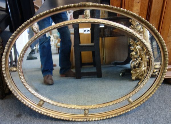 An early 20th century gilt framed oval marginal wall mirror, 83cm wide x 62cm high.