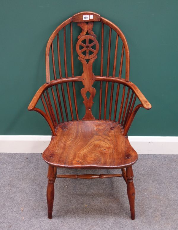 A George III yew and elm wheel back Windsor armchair on turned supports.