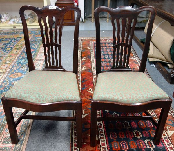 A set of six George III style wavy splat back dining chairs, with serpentine seats on square supports (6).