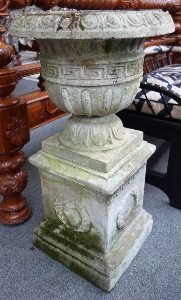 A pair of composition stone garden urns, with Greek key band and semi-fluted bodies, on wreath cast square bases, 78cm high.