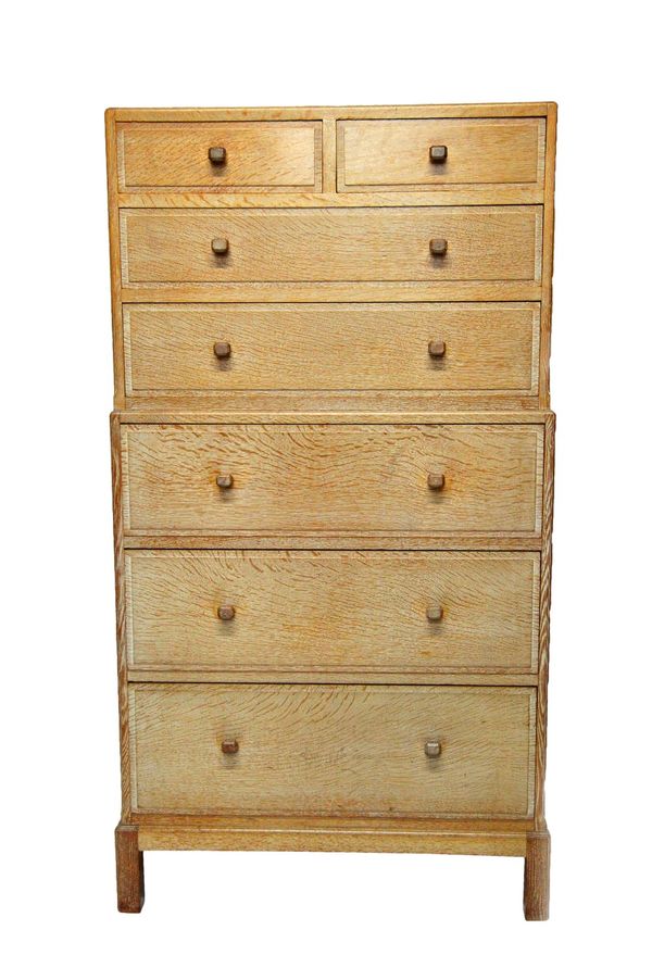 Heals; a mid-20th century framed oak chest on chest of two short and five long graduated drawers, on block feet, 76cm wide x 140cm high, with circular