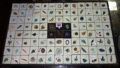 A set of 104 small Studio pottery ceramic tiles painted with leaves in a fitted rectangular tray, lacking one tile. CABProvenance; The Estate of Fleur