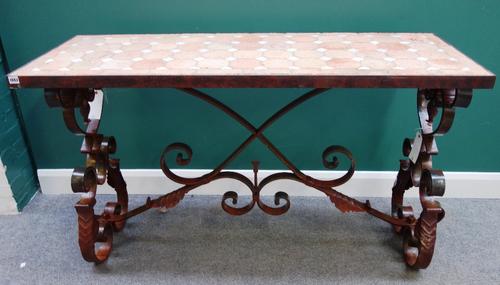 A 20th century console table, the iron bound rectangular tile inset top over a wrought iron base, with shaped stretcher, 52cm wide x 146cm long.
