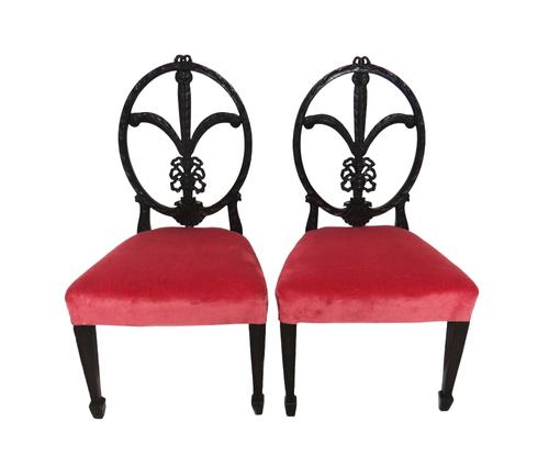 A pair of carved mahogany child's chairs in the George III style, with ribbon tied feather backs (2).  IllustratedProvenance- from the estate of Fleur