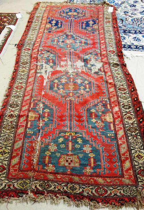 A North West Persian runner, 254cm x 116cm.  I7