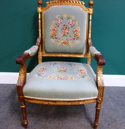 A Louis XVI style gilt framed open armchair, with bow seat on fluted supports.