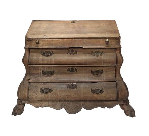 A late 18th/early 19th century Dutch bleached oak bureau, with fall front enclosing a fitted interior, on a bombe base with three drawers on hairy paw