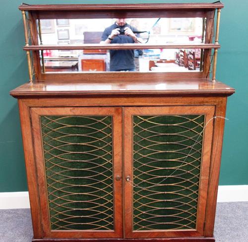 A Regency gilt brass mounted chiffonier, the two tier mirrored shelf back over a pair of grille doors, on plinth base, 122cm wide.
