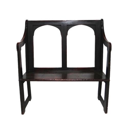 A George III and later, Gothic arch back oak hall bench, with solid seat on dual standard ends, 93cm wide.  IllustratedProvenance- from the estate of