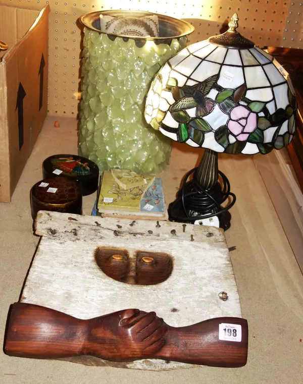 A group of collectables including a wooden wall sculpture depicting a face and hands, Tiffany stye lamp, tiles, boxes and sundry. (qty) S1BProvenance;