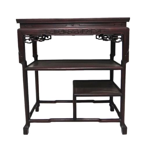 A late 19th century Chinese hardwood display table, the rectangular top with pierced frieze brackets over two various open tiers on carved block feet,