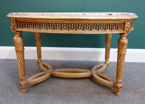 A Louis XVI style coffee table, the oval marble inset top on four spiral fluted supports, united by shaped stretcher, 90cm wide.