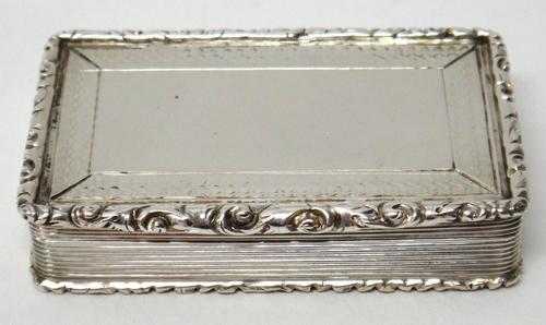 A Victorian silver rectangular snuff box, decorated to the borders of the lid and to the base, with engine turning within scroll moulded borders and w