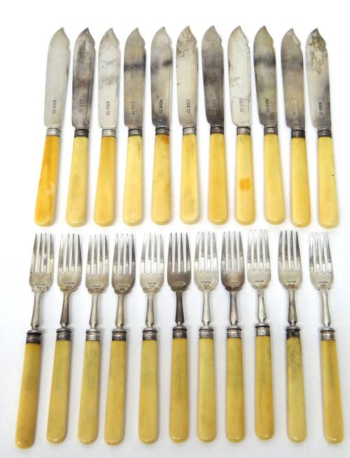 Eleven silver bladed fish knives, with ivory handles, Sheffield 1921, seven silver pronged fish forks, with ivory handles, Sheffield 1921 and four sil