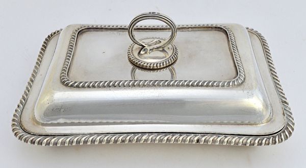 A late Victorian silver rectangular lidded entree dish, decorated with gadrooned rims, with a detachable handle, London 1897, weight 1690 gms.  Illust