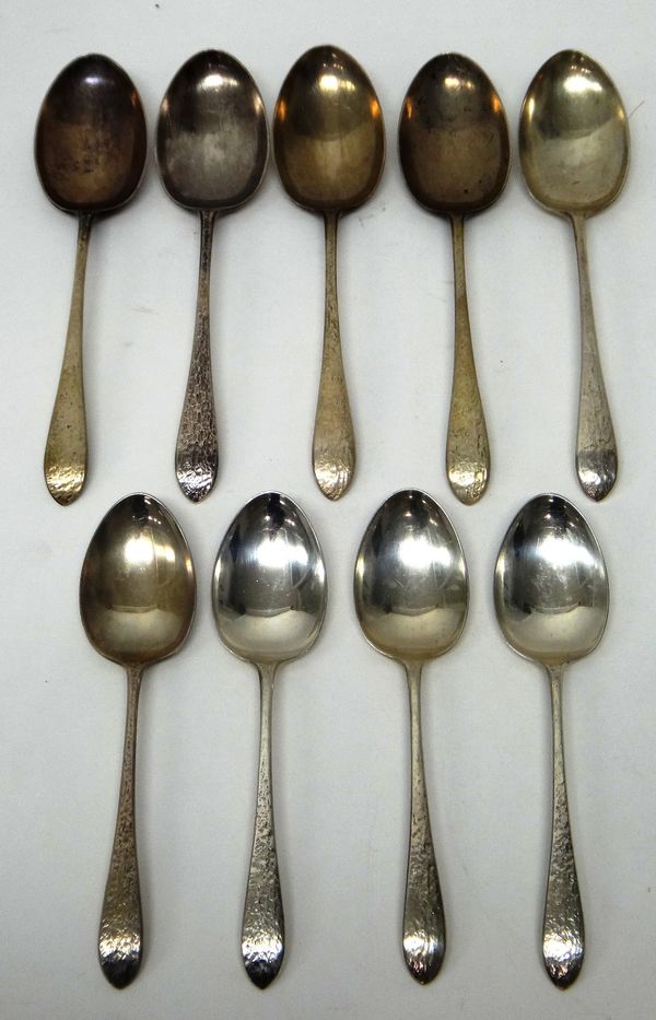 Silver table flatware, comprising; five tablespoons, Sheffield 1931 and four dessert spoons, Sheffield 1931, the handles having a cast textured decora