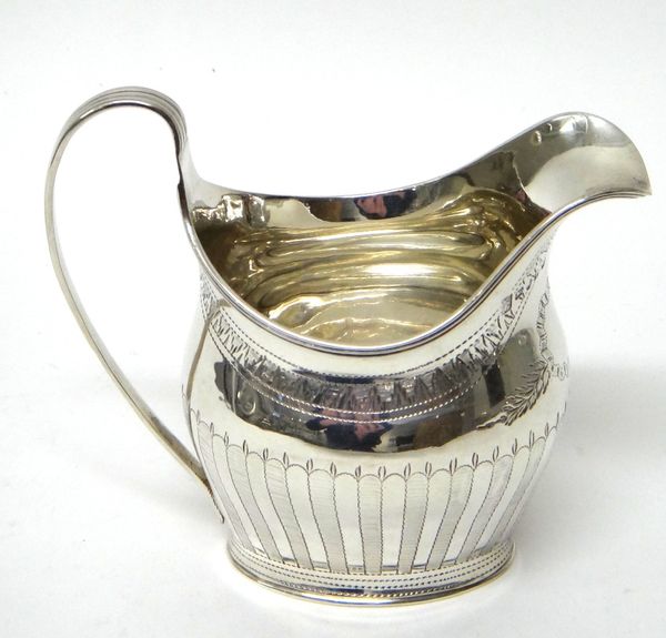 A George III silver helmet shaped milk jug, with engraved banded decoration with a ridged handle and on an oval foot, maker Sammuel Godbehere, Edward