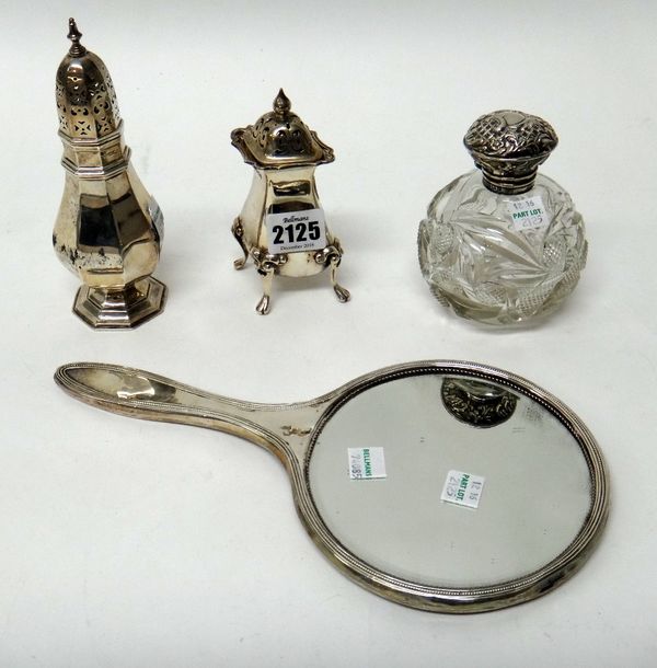 Silver and silver mounted wares, comprising; a large pepperette, raised on four paw feet, Birmingham 1912, an octagonal sugar caster, Sheffield 1912,