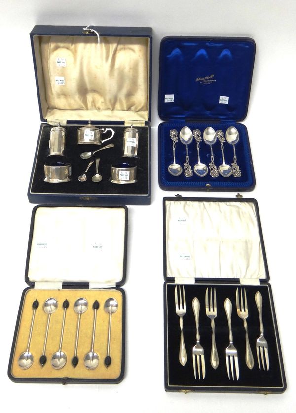 A silver five piece condiment set, Birmingham 1937, with blue glass liners, cased, a set of six silver coffee spoons, the handles with coffee bean fin