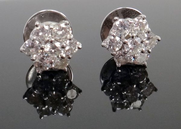 A pair of diamond set seven stone cluster earstuds, each in a hexagonal design, mounted with circular cut diamonds, the backs with post fittings and w