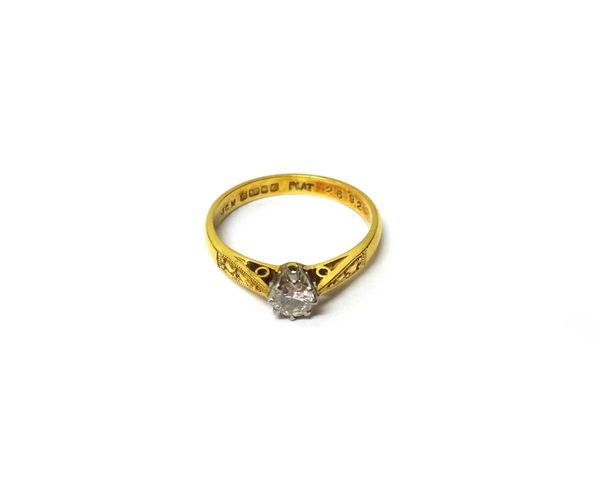 An 18ct gold and platinum, diamond set single stone ring, claw set with a circular cut diamond, between decorated shoulders, ring size K and  half, wi