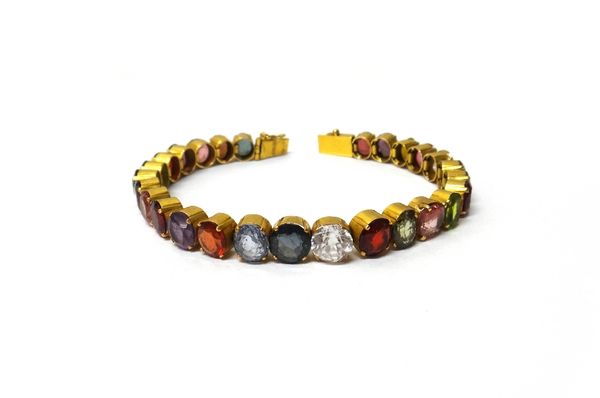 A gold and vary coloured gemstone and paste set bracelet, possible Ceylonese, on a snap clasp, length approx 17cm.