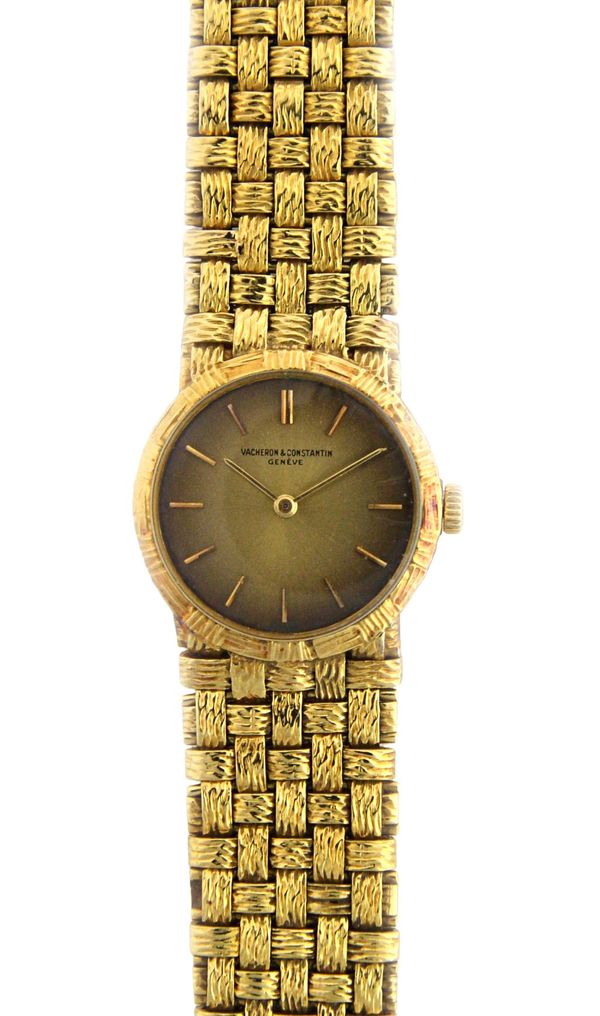 A lady's gold Vacheron & Constantin bracelet wristwatch, the signed circular gilt dial with baton shaped numerals, on a textured woven link bracelet,