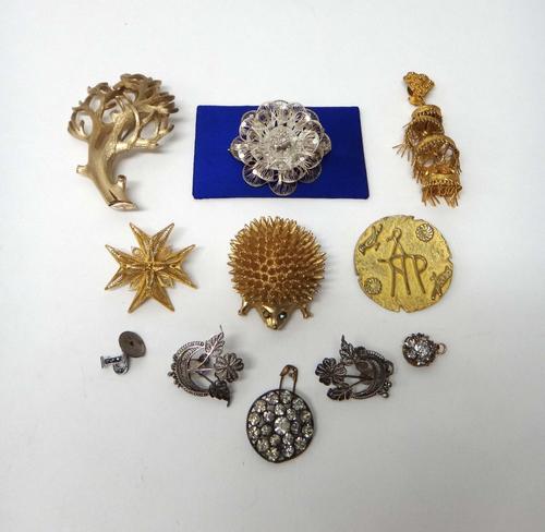 A gold filigree brooch, designed as a Maltese cross, a Trifari costume brooch, designed as a spray, a costume brooch designed as a hedgehog, two furth