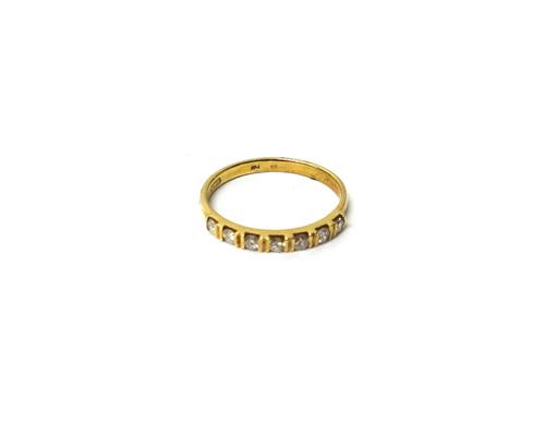 A 9ct gold and diamond set seven stone half hoop ring, mounted with a row of circular cut diamonds, ring size N, with a case.