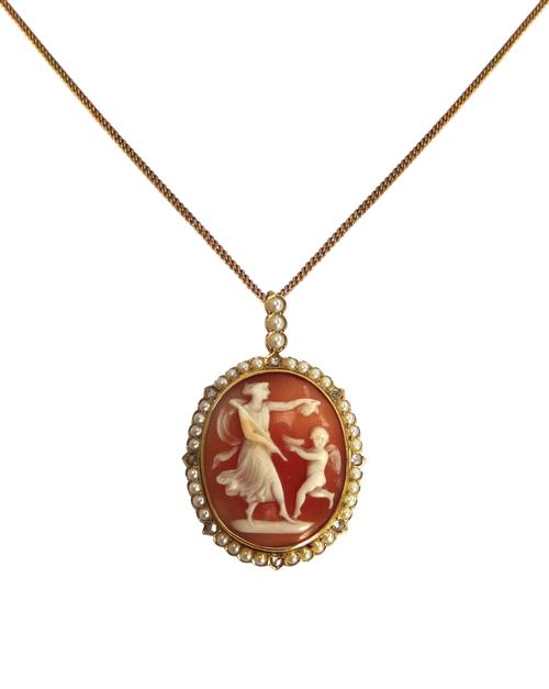 A gold, seed pearl and rose diamond set oval shell cameo pendant, the cameo carved as a classical female figure with a cherub holding a dish, in a bor