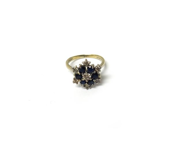 An 18ct white gold, sapphire and diamond cluster ring, in a hexagonal snowflake shaped design, London 1978, ring size K and a half, with a case.