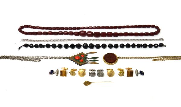 A gold stick pin, the finial designed as a classical oil lamp, a single row necklace of imitation amber beads, another bead necklace, two pendants wit