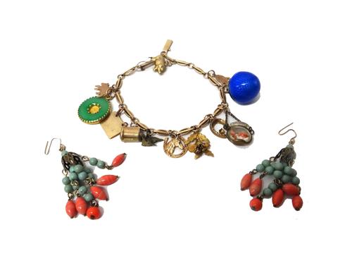 A gold bar and oval link charm bracelet, fitted with twelve gold and other charms, including a pig and a horses head within a horseshoe, a pair of imi