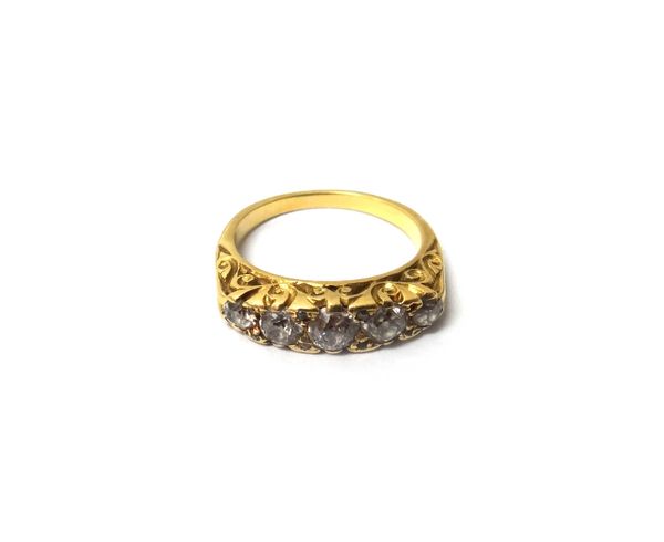 A gold and diamond set five stone ring, mounted with a row of cushion shaped diamonds graduating in size to the centre stone and with pairs of diamond