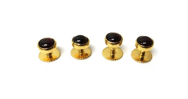 A set of four 9ct gold and carbuncle garnet set single stone dress studs, London 1986, combined gross weight 10.1 gms.