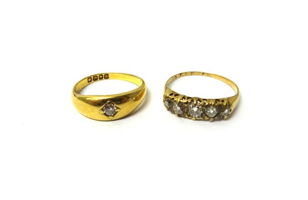 An 18ct gold and diamond five stone ring, mounted with a row of cushion shaped diamonds, ring size O and an 18ct gold ring, gypsy set with a cushion s