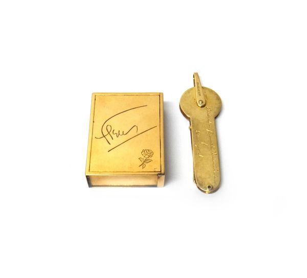 A rectangular gold slide action vesta box, apparently unmarked, probably American, weight 45 gms and a gold cased gilt metal key, the suspension loop