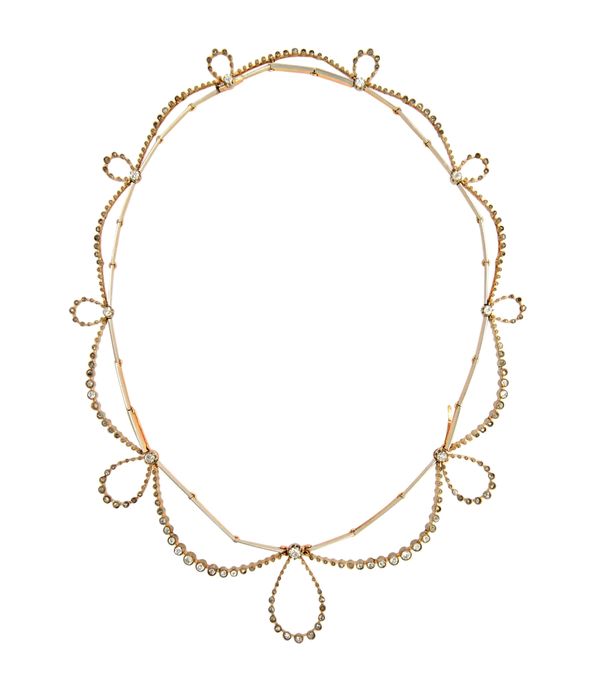 A diamond necklace, in a graduating looped and bar link design, on a snap clasp, mounted with cushion shaped and rose cut diamonds, (one diamond lacki