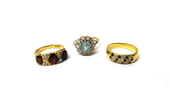 An 18ct gold ring, mounted with three oval cut garnets and with two pairs of circular cut diamonds mounted at intervals, an 18ct gold ring, mounted wi