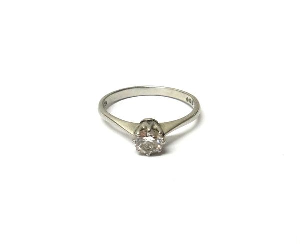 A platinum and diamond single stone ring, claw set with a circular cut diamond, ring size N and a half, with a case.