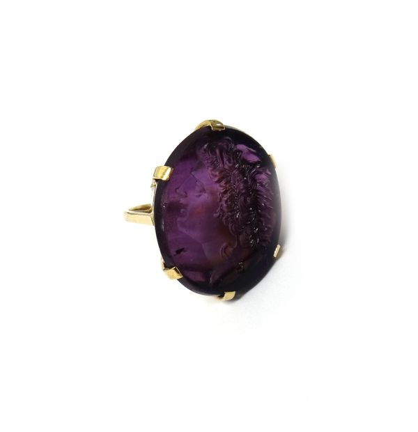 A gold mounted oval mauve paste intaglio ring, moulded as a classical portrait within a claw setting, detailed 9 CT, ring size O and a half, with a ca