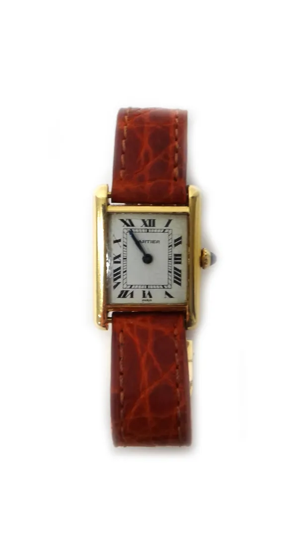 A Cartier lady's rectangular cased Tank wristwatch, the signed cream coloured dial with black Roman numerals and with blued steel hands, detailed to t