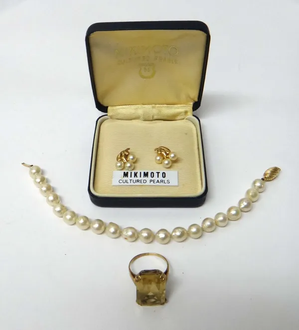 A gold ring, claw set with a rectangular cut citrine, ring size M and a half, a pair of 9ct gold and cultured pearl earstuds, the backs with post and