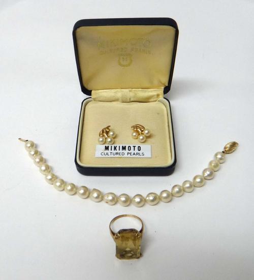 A gold ring, claw set with a rectangular cut citrine, ring size M and a half, a pair of 9ct gold and cultured pearl earstuds, the backs with post and