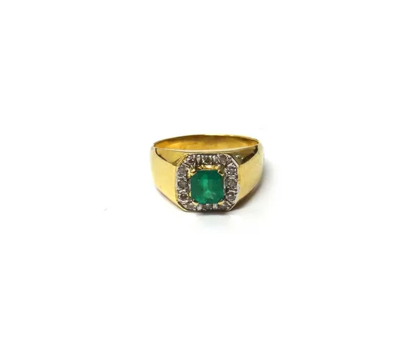 A gold, emerald and diamond set ring, claw set with the cut cornered rectangular step cut emerald at the centre, in a surround of circular cut diamond