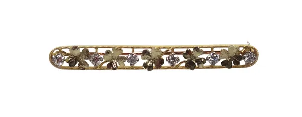 A gold and diamond set brooch, designed as a row of five four leaved clovers and with six circular cut diamonds mounted at intervals, otherwise in an