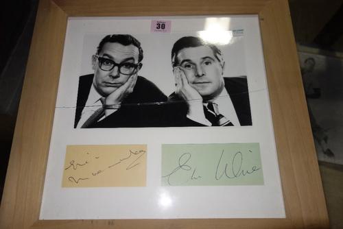 A framed photo of Eric Morecambe and Ernie Wise, with signatures below. All potential purchasers should satisfy themselves with authenticity of signat
