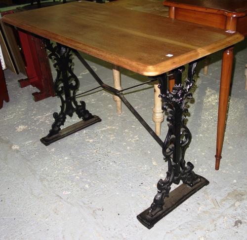 A pub table with cast iron base and mahogany top, 108cm wide.  GAL