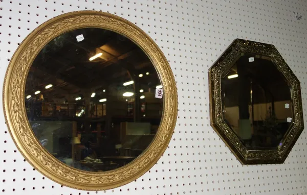 A circular gilt framed wall mirror and an octagonal brass mirror. (2)  A1