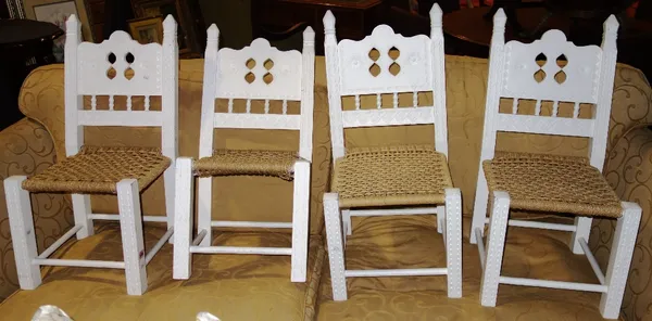 A set of four 20th century white painted child's chairs with rush seats. (4)  F3Provenance; The Estate of Fleur Cowles